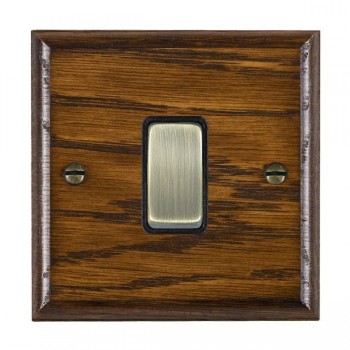 Hamilton Woods Ovolo Dark Oak 1 Gang 10AX 2 Way Switch with Antique Brass Rocker and Black Surround