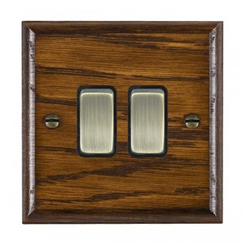 Hamilton Woods Ovolo Dark Oak 2 Gang 10AX 2 Way Switch with Antique Brass Rockers and Black Surround