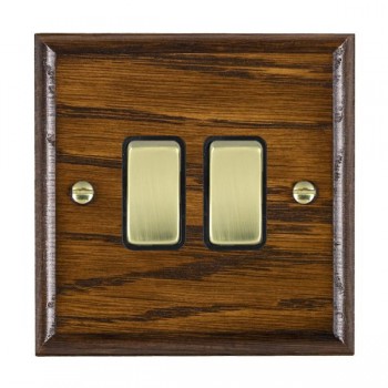 Hamilton Woods Ovolo Dark Oak 2 Gang 10AX 2 Way Switch with Polished Brass Rockers and White Surround