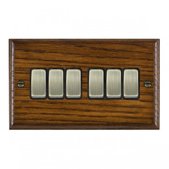 Hamilton Woods Ovolo Dark Oak 6 Gang 10AX 2 Way Switch with Antique Brass Rockers and Black Surround