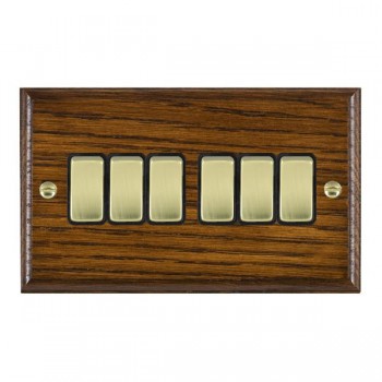 Hamilton Woods Ovolo Dark Oak 6 Gang 10AX 2 Way Switch with Polished Brass Rockers and Black Surround