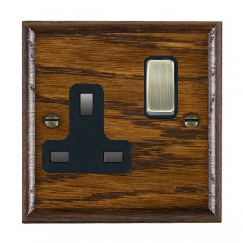 Hamilton Woods Ovolo Dark Oak 1 Gang 13A Double Pole Switched Socket with Antique Brass Rocker and Black Surround