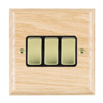 Hamilton Woods Ovolo Light Oak 3 Gang 10AX 2 Way Switch with Polished Brass Rockers and Black Surround