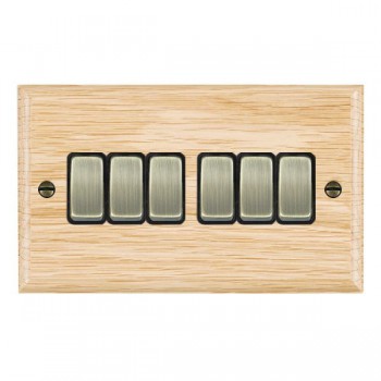 Hamilton Woods Ovolo Light Oak 6 Gang 10AX 2 Way Switch with Antique Brass Rockers and Black Surround