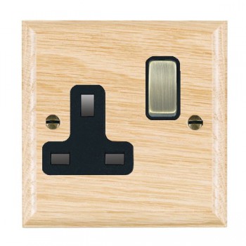 Hamilton Woods Ovolo Light Oak 1 Gang 13A Double Pole Switched Socket with Antique Brass Rocker and Black Surround