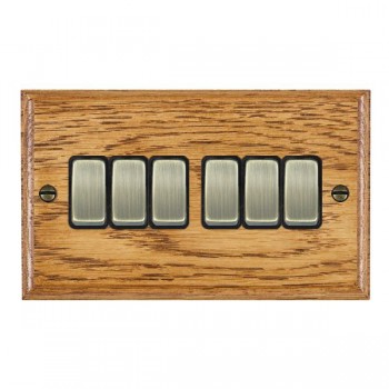 Hamilton Woods Ovolo Medium Oak 6 Gang 10AX 2 Way Switch with Antique Brass Rockers and Black Surround