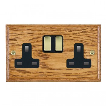Hamilton Woods Ovolo Medium Oak 2 Gang 13A Double Pole Switched Socket with Polished Brass Rockers and Black Surround
